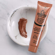Dr PAWPAW Rich Mocha Balm tube with a swatch of the tinted balm in a marble dish