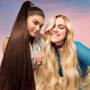 Two models with long, glossy hair after using Garnier Pineapple Hair Drink